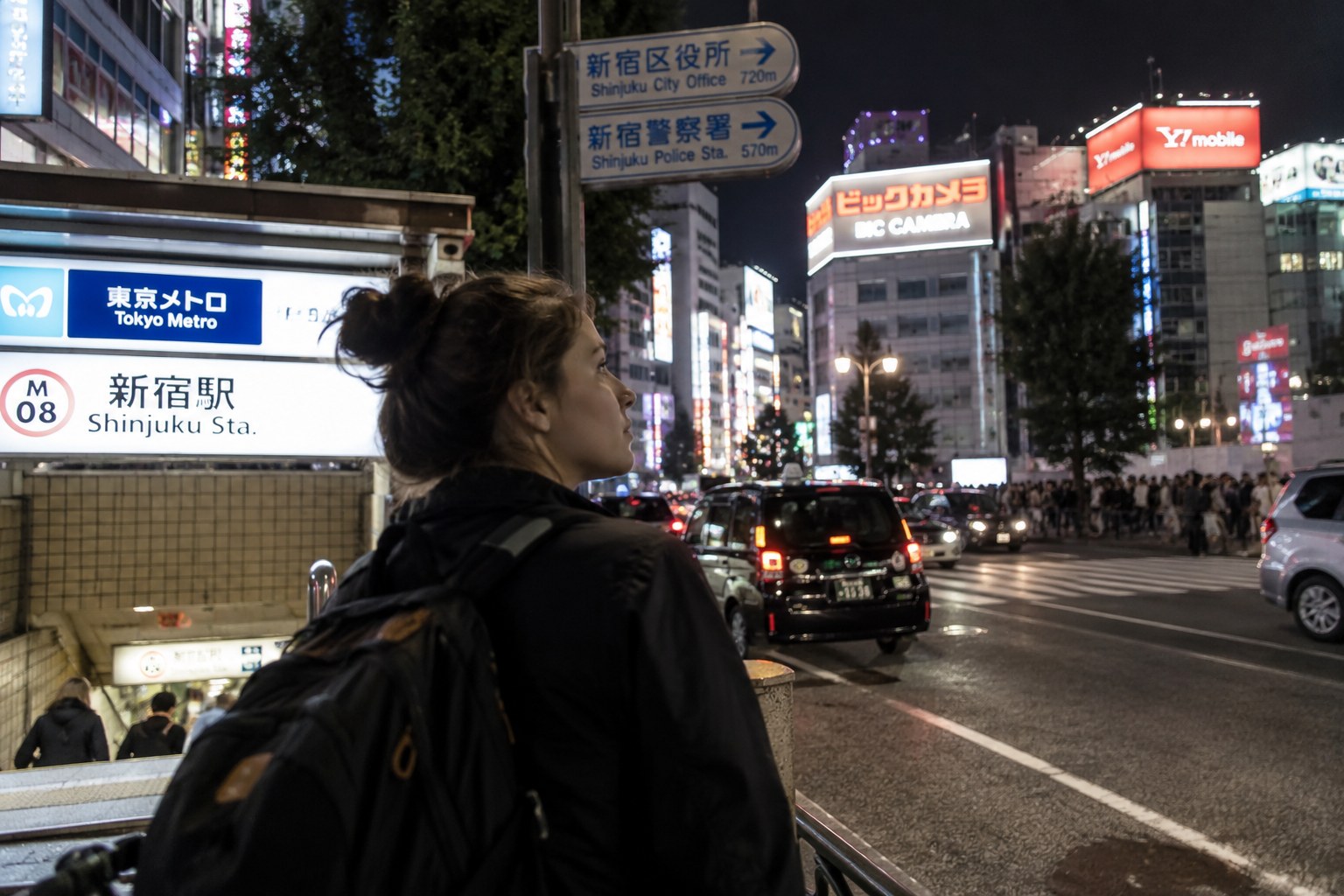 Traveler arriving in Shinjuku on her first night in Tokyo