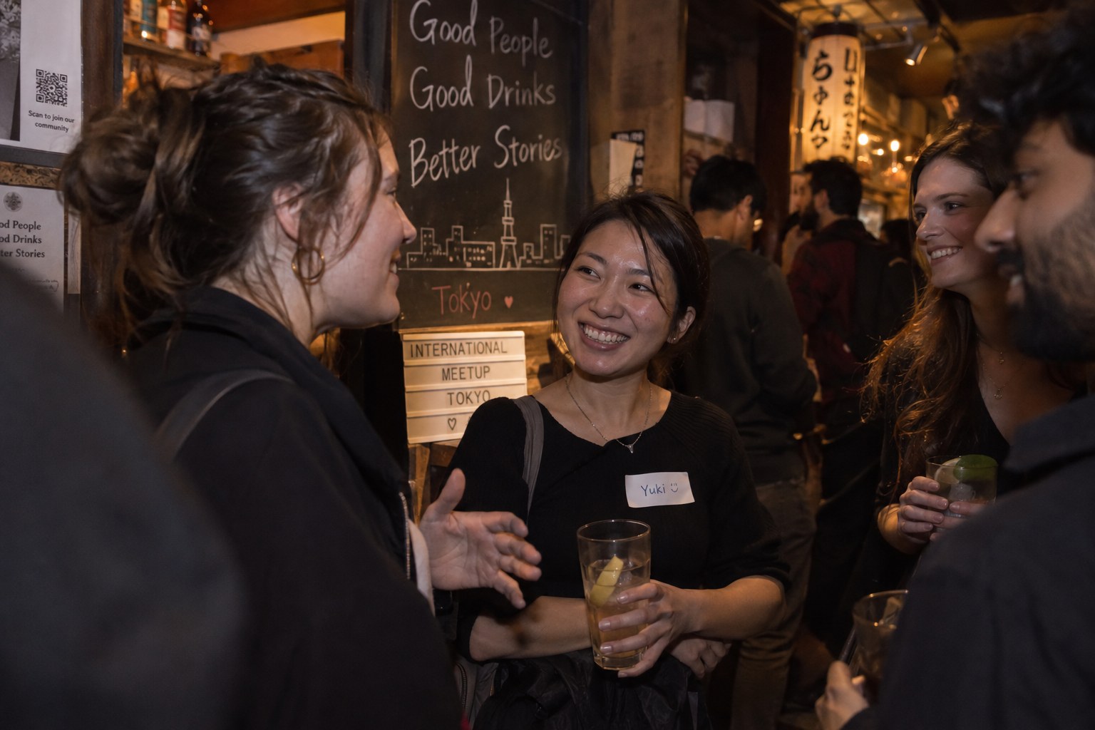 Women meeting naturally at a small international social night in Tokyo